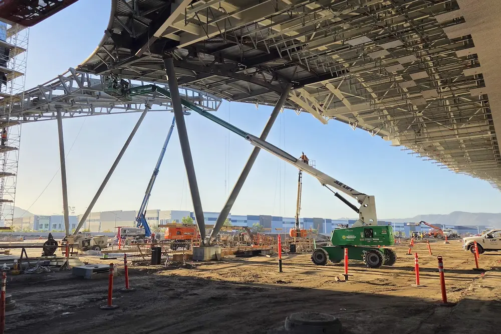 The new passenger terminal at Hollywood Burbank Airport is inspired by Hollywood, which is visible in design elements like the entry sequence, spotlight columns, terrazzo patterns, and the curvature of the roof form (pictured here).
