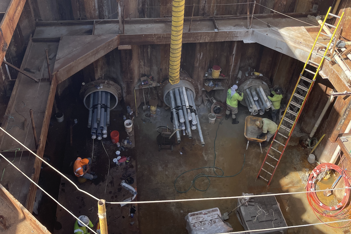 The microtunneling jacking pit runs electrical utility lines under a canal.