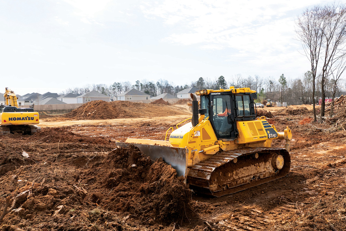 At a Kennedy Excavating job site, an operator piles up material with a Komatsu D61PXi-24 IMC Dozer.