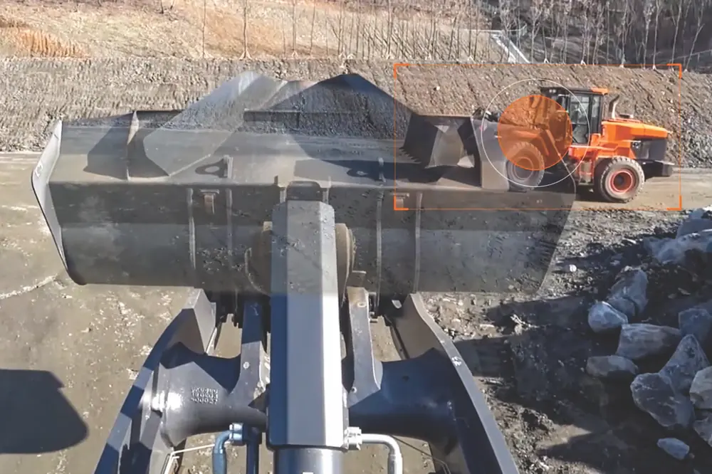 Using two cameras, transparent bucket technology stitches together the video feeds so operators can “see through” the bucket.