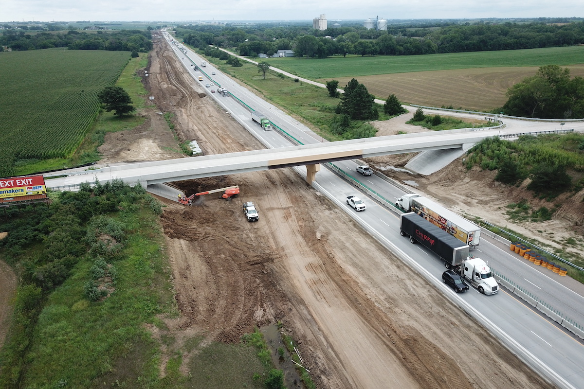 Traffic is shifted onto new eastbound pavement for Phase 2, while the new westbound lanes are under construction. Meanwhile, a painting crew is working on painting the north half of one of the new overhead bridges.