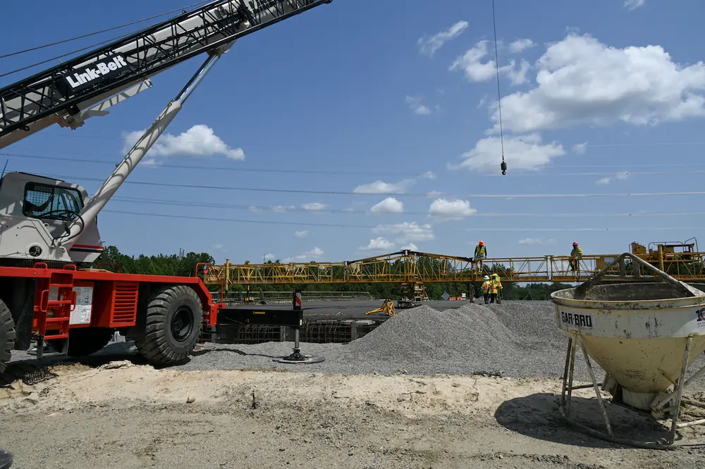 A screed is erected across the rebar framework of the I-77 Exit 26 overpass bridge.