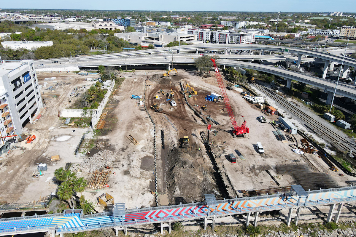 Crews work on rerouting the new 84-foot-wide channel to flow through the city to the St. Johns River.