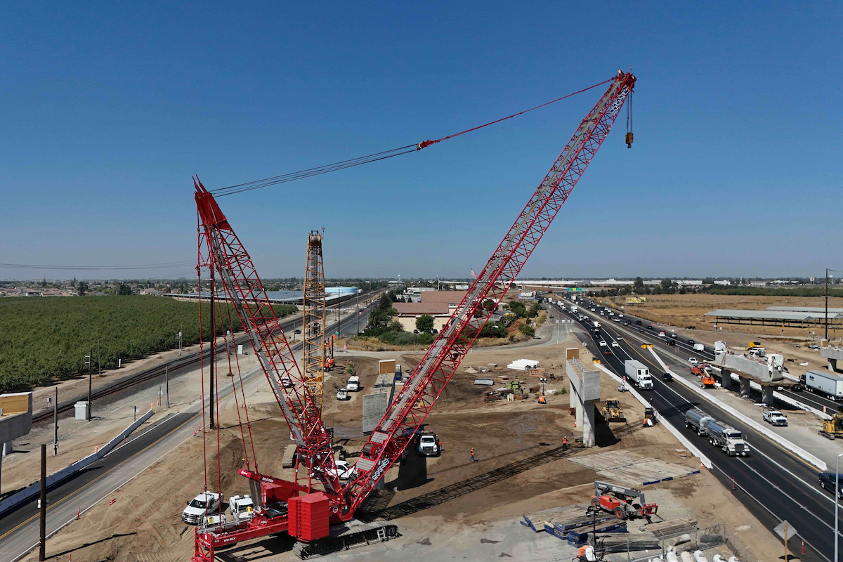 Cranes are positioned ahead of nighttime work to position girders on top of the supports for the Austin Road overcrossing.