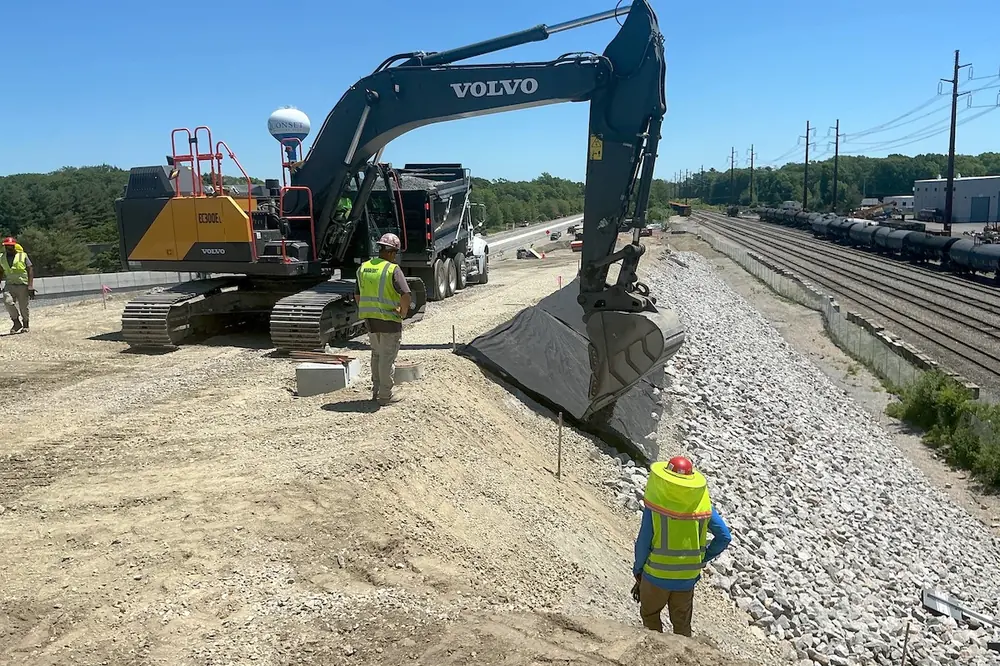 A Volvo EC300E Excavator is used for earthwork during construction of the I-95 "Missing Move" and Quonset Ramps Construction Project.