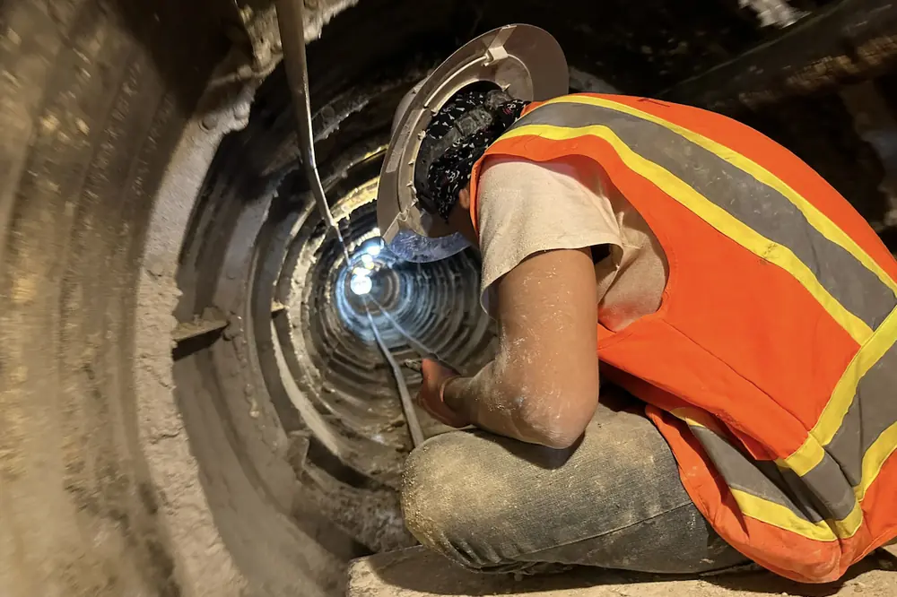 A team member works in a 300-foot hand tunnel.