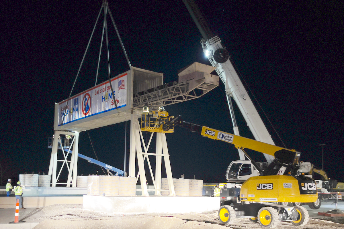 The Duit Construction team installs a 20-foot-high conveyor bridge that will transfer concrete over the turnpike to the inside phase of the project.