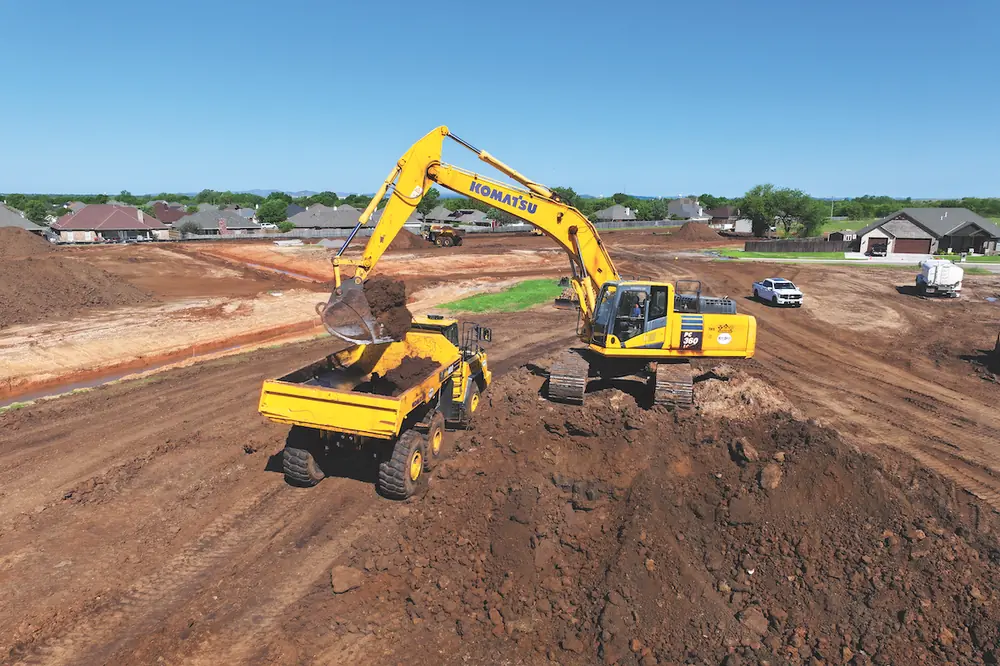 An operator loads a rented Komatsu articulated haul truck with T & G Construction’s Komatsu PC360LC Excavator on a job site in Lawton, Oklahoma.