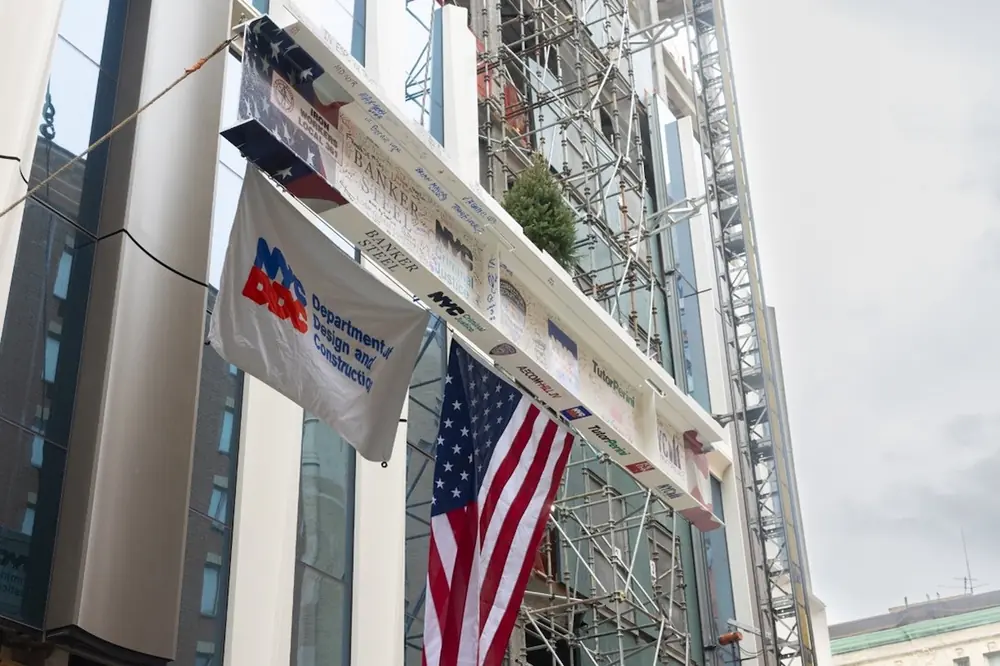 The last piece of structural steel is lifted into place for the new Brooklyn jail.