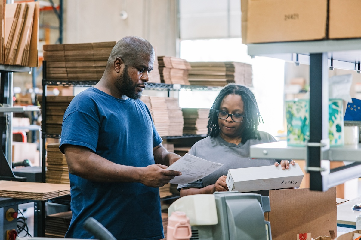 As part of the work release program, Ken White (left) works the same hours and earns the same pay rate as other employees.