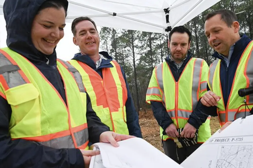 From left to right: NCDOT Division 5 Division Engineer Becca Gallas, NCDOT Secretary Daniel Johnson, Federal Railroad Administration Deputy Administrator Drew Feeley, and NCDOT Rail Division Director Jason Orthner review plans for the S‑Line grade separation project on New Hope Church Road in Raleigh.