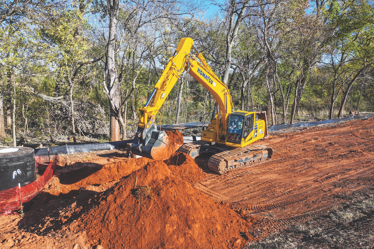 Operator Jesus Collazo digs a trench with a Komatsu PC290LCi-11 IMC Excavator on a road widening project near Pawnee, Oklahoma.