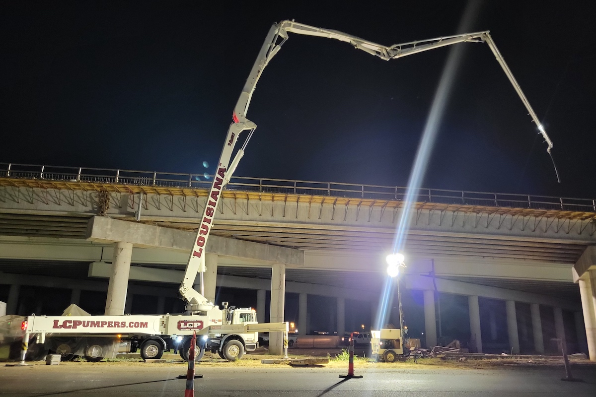 Concrete is poured on the bridge deck for the railroad overpass.
