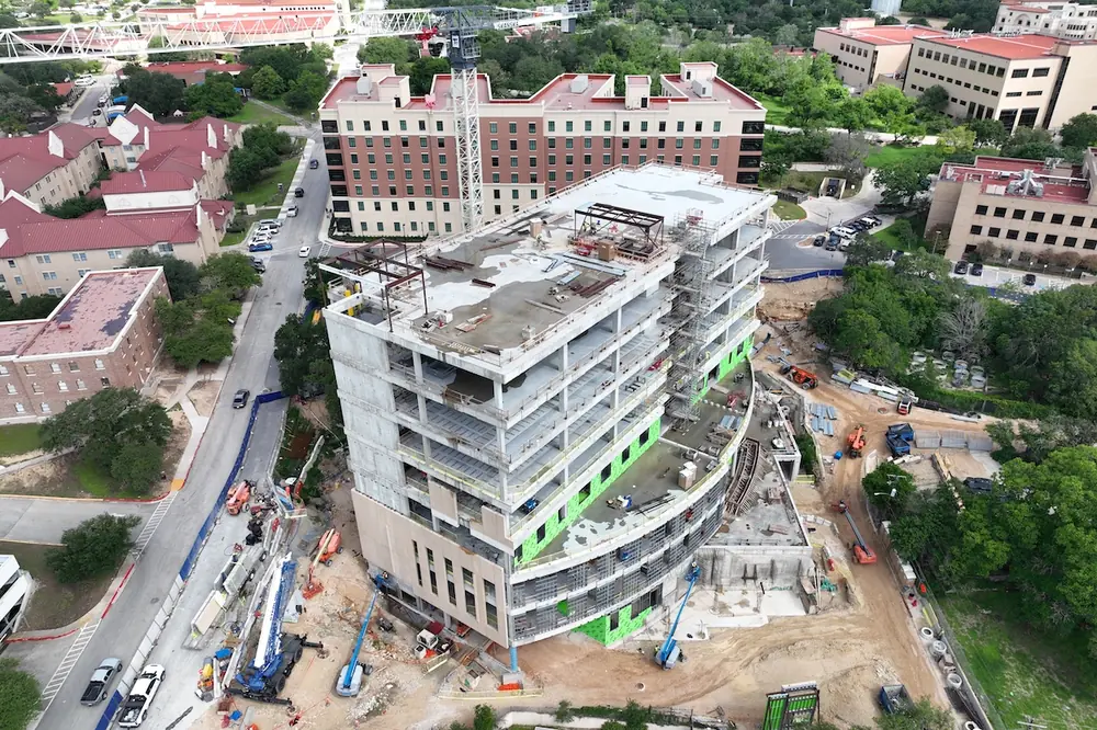 The cast-in-place concrete building will include classrooms, conference spaces, and faculty spaces on the upper floors.