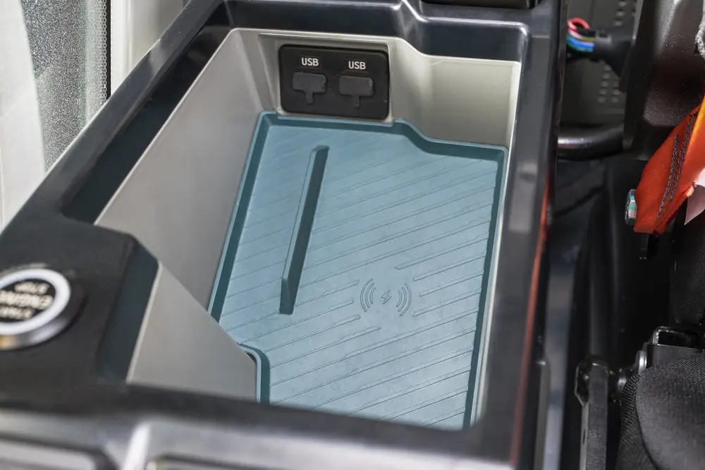 Cab features like wireless phone chargers upgrade the daily experience to keep operators comfortable and organized.