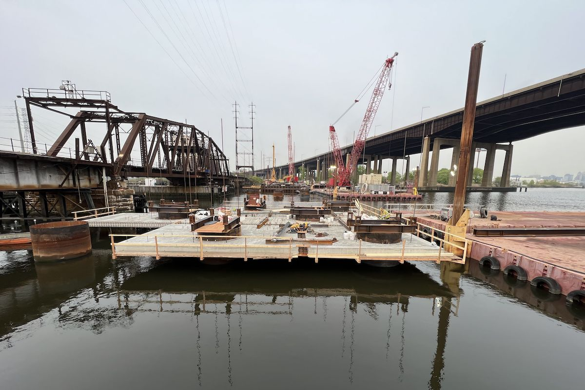 Pictured here is the Pier 2 soffit slab construction. Precast slabs are being placed over each drilled shaft casing, which will later be locked together with concrete poured between each segment.