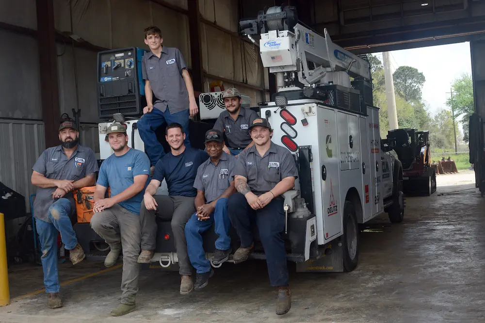 Members of the Broussard branch’s service department gather for a group photo on a service truck.