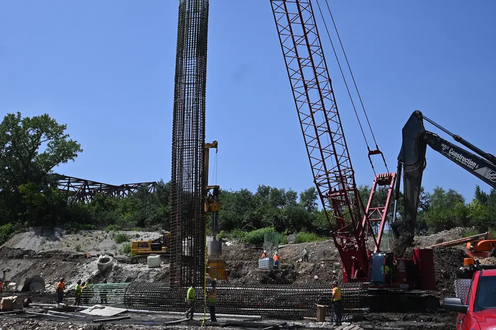 Workers position a rebar cage for a pier foundation on the Interstate 80 Reconstruction Project, which involves upgrading over 30 bridges.