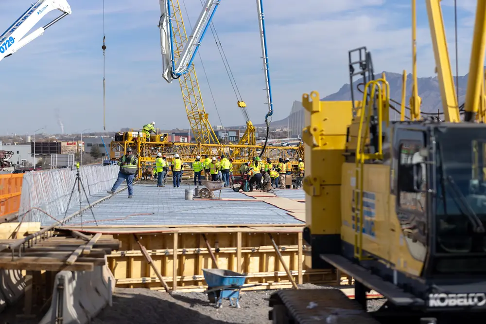 Concrete is poured for the final section of bridge deck on northbound I-25 over Comanche Road.