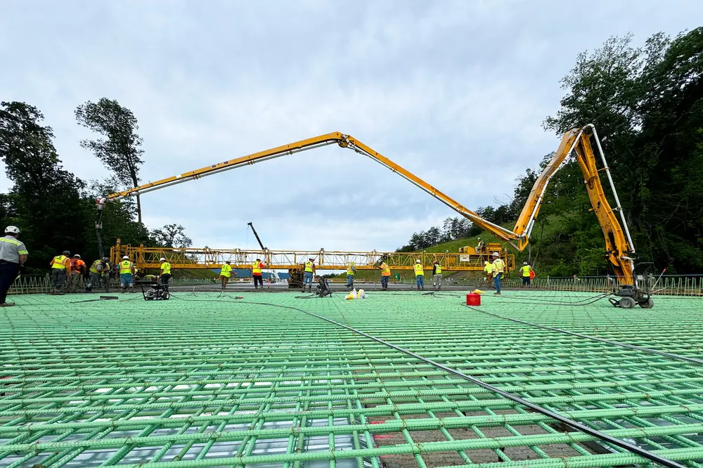 Crews pour concrete on one of four bulb-tee bridges being constructed for the Newport Bypass Project.