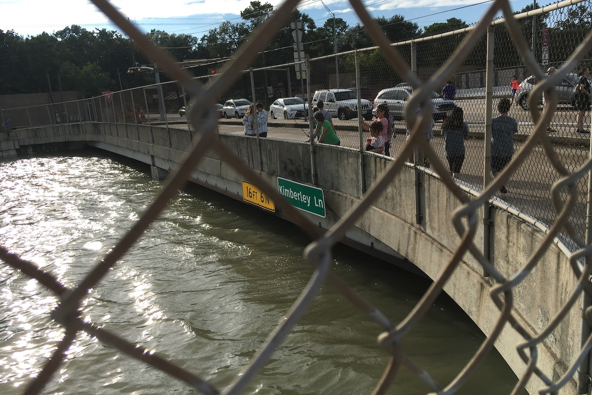 Road signs meet rising tides on a major freeway in Houston, Texas.