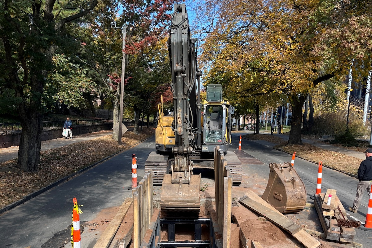New RCP storm drain is installed in a busy New Haven street using timber sheeting, left in place for permanent support of utilities.