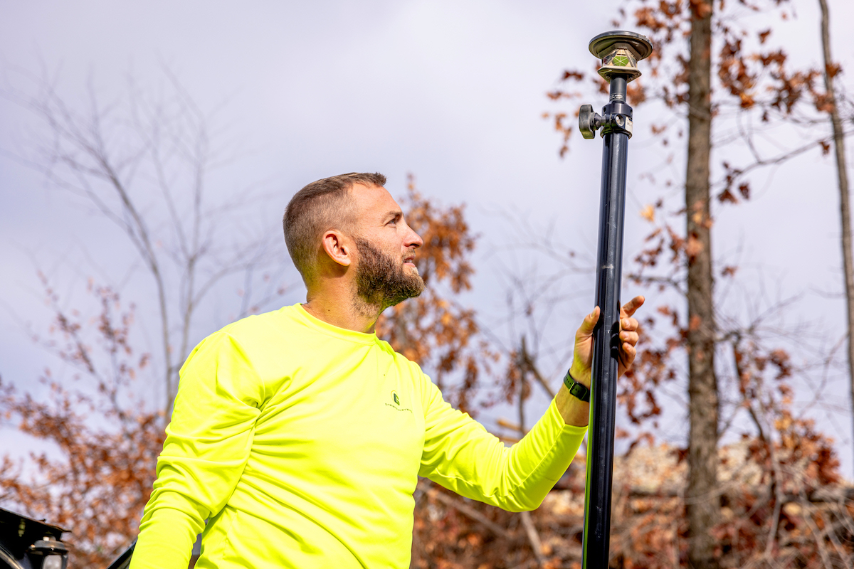Graham completes installation of the prism on his CTL. With the new technology, work that once required multiple personnel can now be done by a single person.