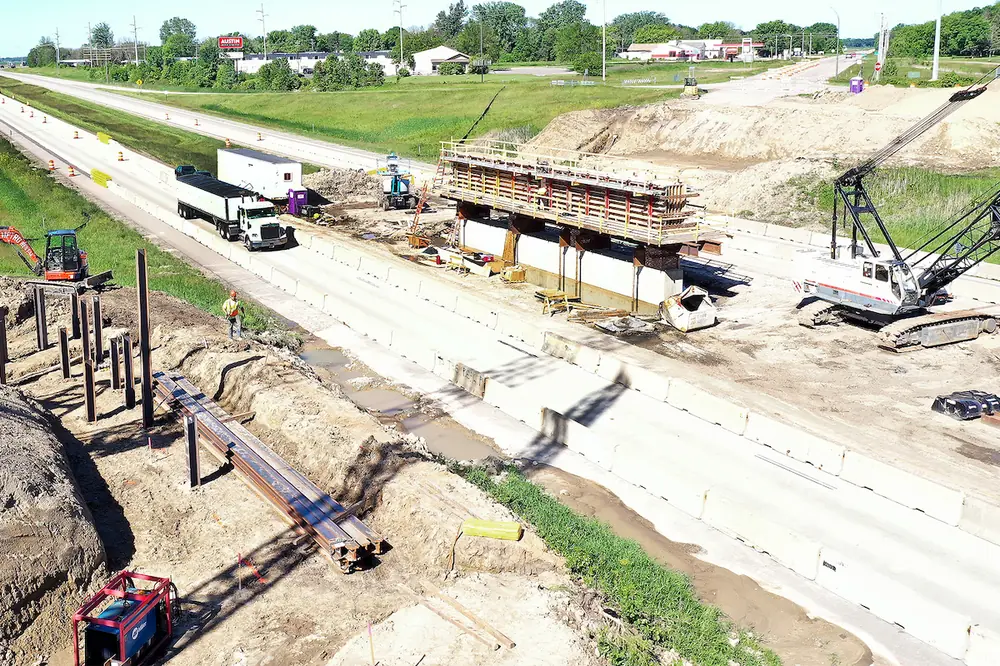 Workers construct the pier and abutments for the Highway 105/Oakland Avenue bridge.