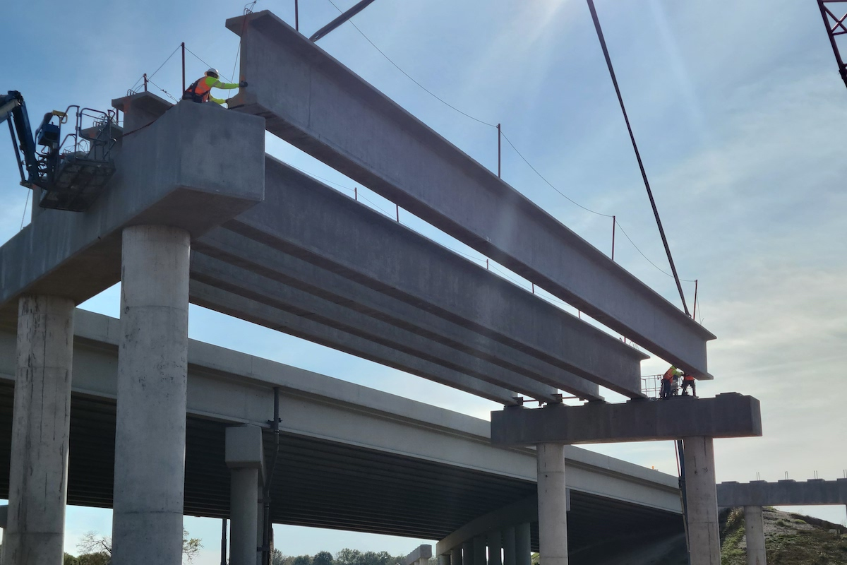 The construction team sets girders onto pier caps.