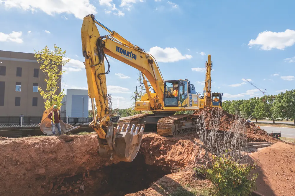 To make space for a manhole, an operator uses a Komatsu PC490LC Excavator to efficiently remove material.