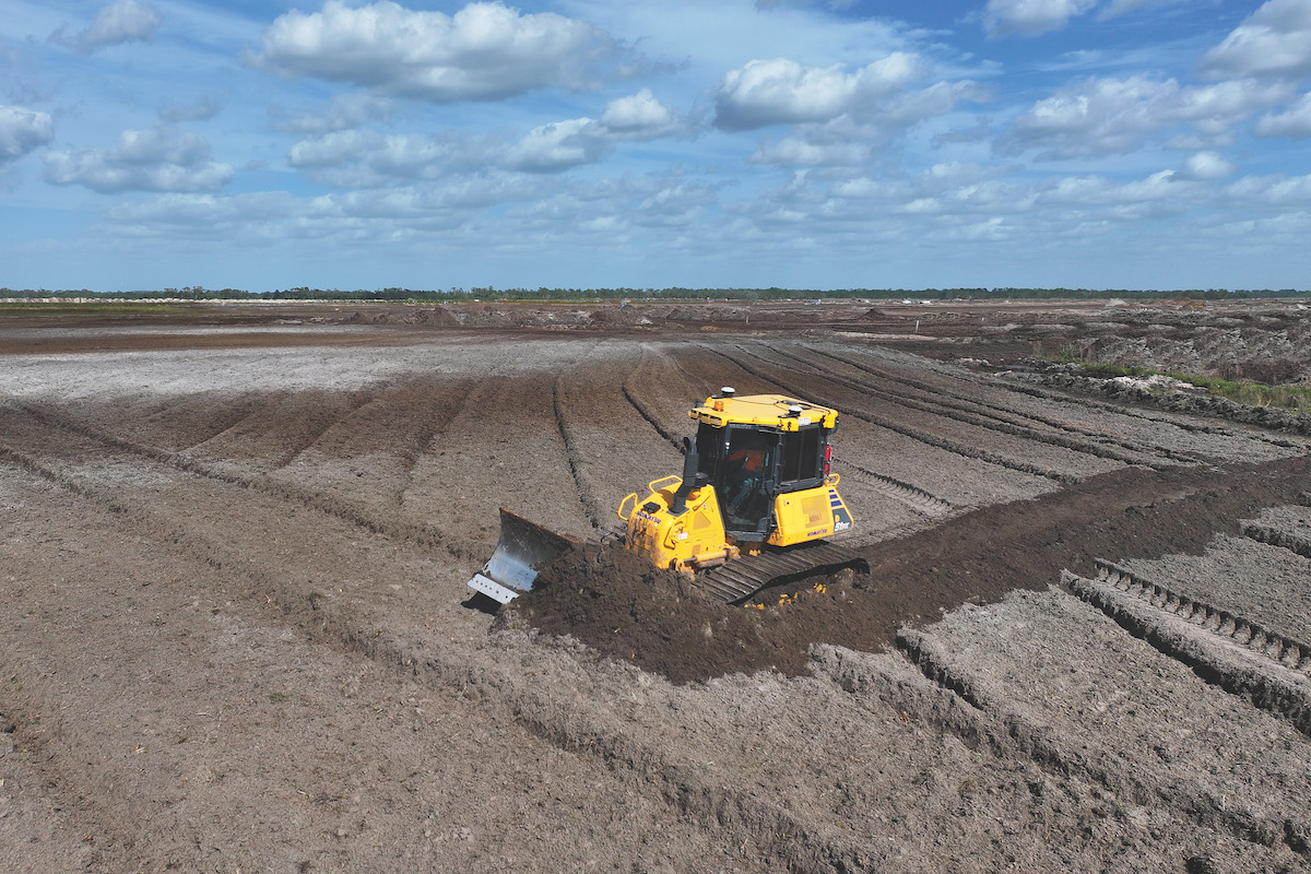 An operator grades a job site with a Komatsu D51PX-24 Dozer.