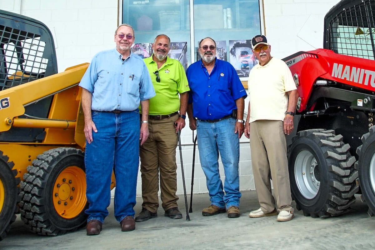 From left to right: Brett, Bruce, and Brad Bowman pose with Umdenstock.