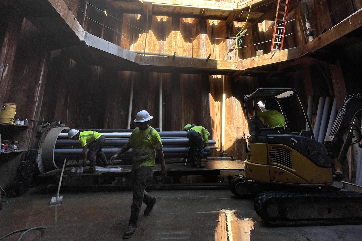 The construction team installs conduit at the microtunneling jacking pit near Kokea Street for the electrical utility lines.