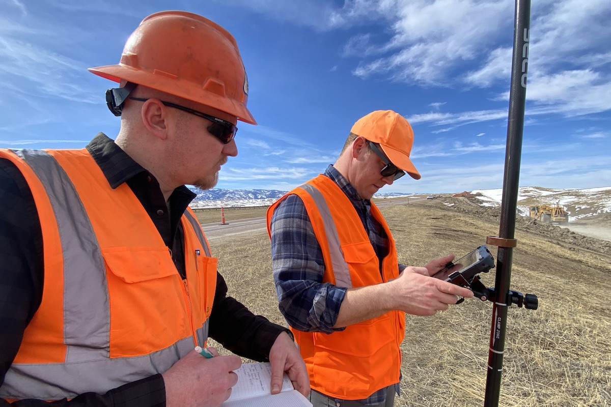 Construction Staff Tech Justin White and Sheridan Project Engineer Wes Oellerich collect data points to confirm slope grade at a slide location on I-90.
