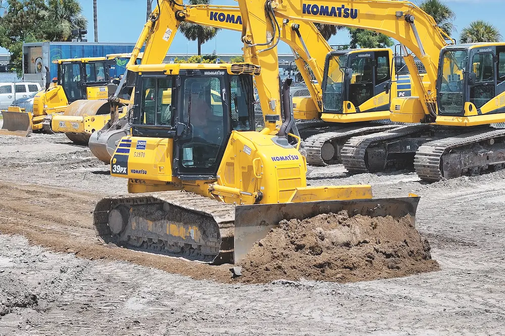 With a Komatsu D39PX-24 Dozer, an operator cuts the surface to grade.