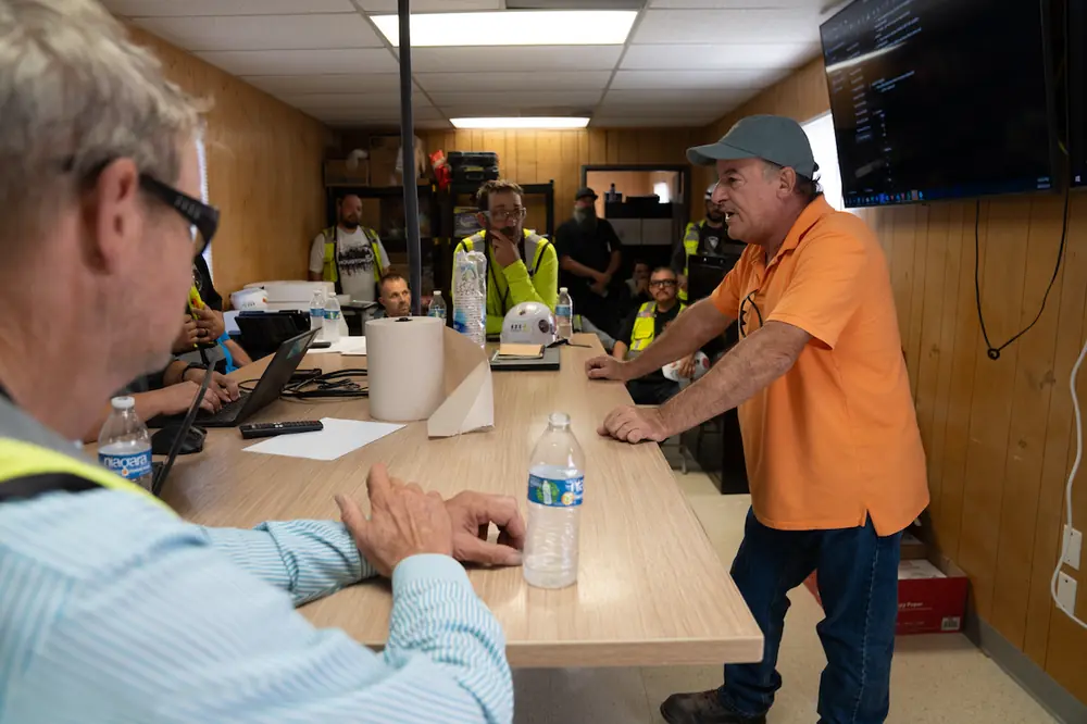 Field leadership gathers in a trailer for a planning session to assess details and make decisions while there is still time to act.