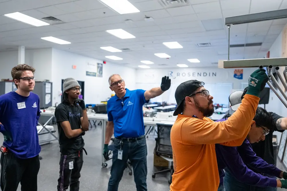 Mike Greenawalt (third from left) works with pre-apprentices.