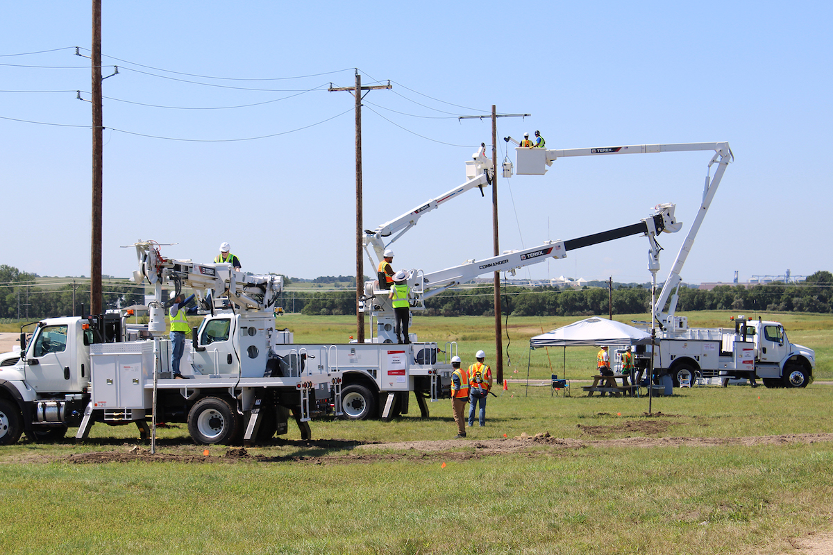 Participants set screw anchors on digger derricks and learn about the top controls on bucket trucks.