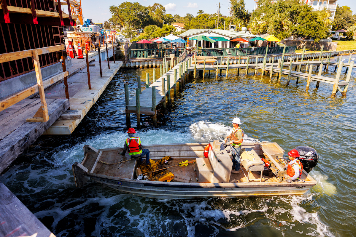 Superior Construction marine crews operate from a work boat during waterside construction operations for the Brooks Bridge Replacement Project.