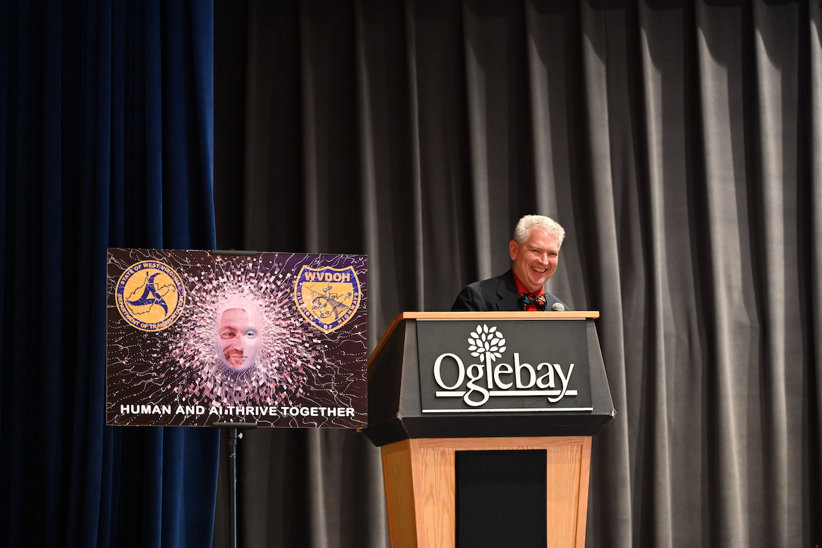 Rumbaugh gives a speech at the department’s annual IT conference.