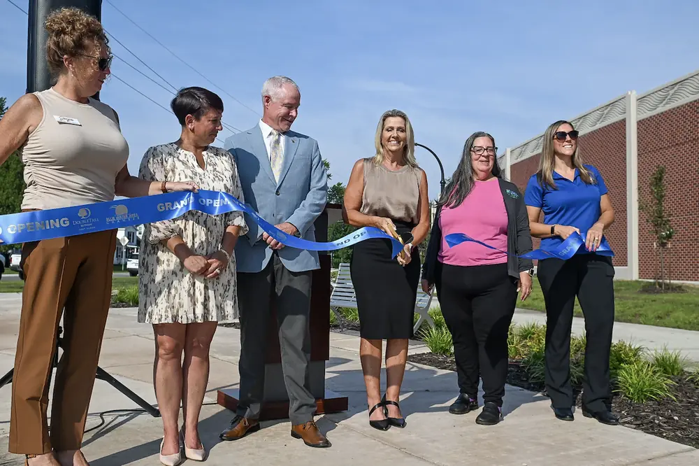 Local officials and MDOT staff celebrate the opening of the Scott Avenue path and greenspace with a ribbon-cutting celebration.