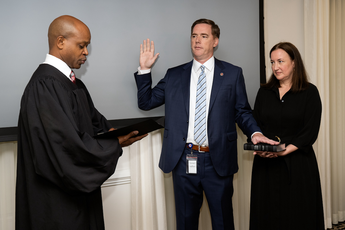 Secretary Daniel Johnson is sworn in to his new position.