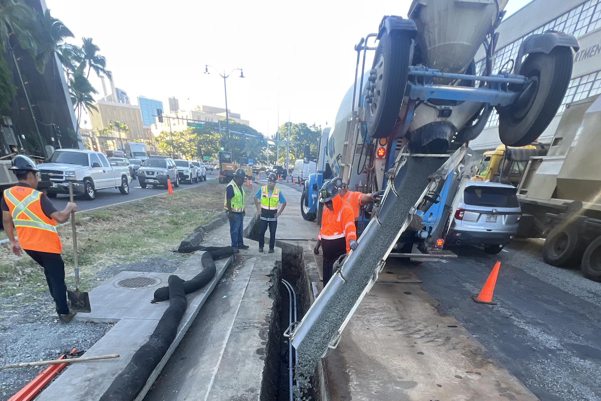 A traffic signal duct bank is backfilled with concrete on Nimitz Highway near Fort Street.