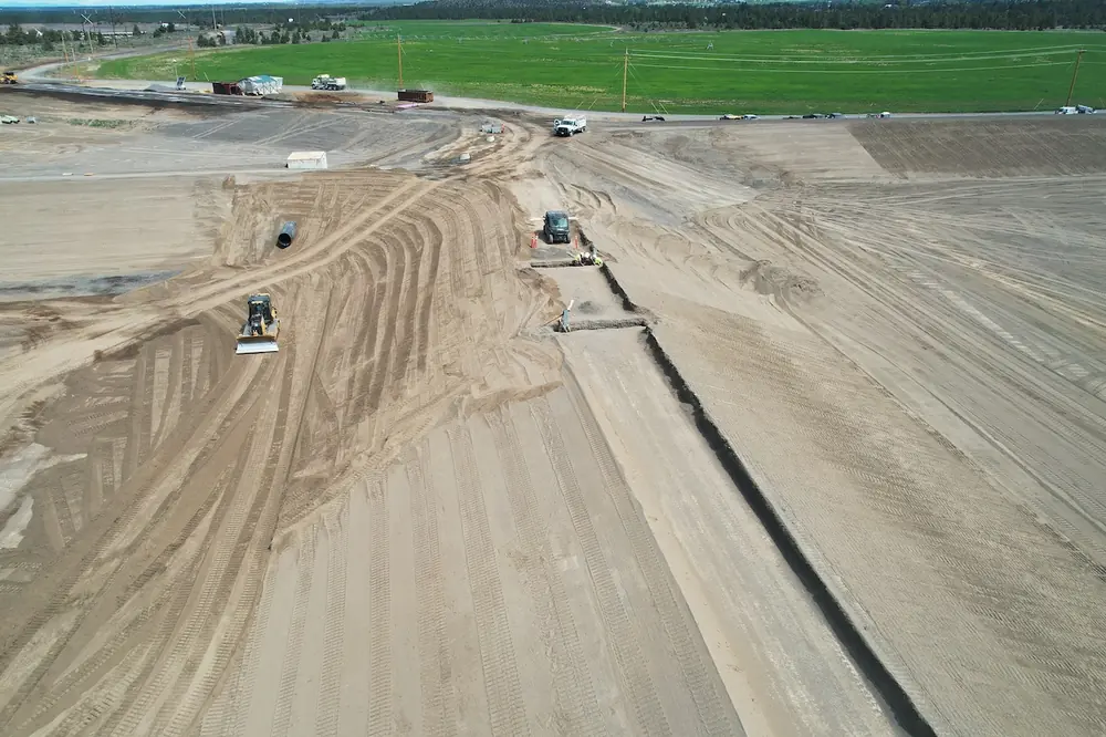 Crews perform final grading and aerator anchor trench preparation for Lagoon 1. (Photo courtesy of Taylor Northwest)