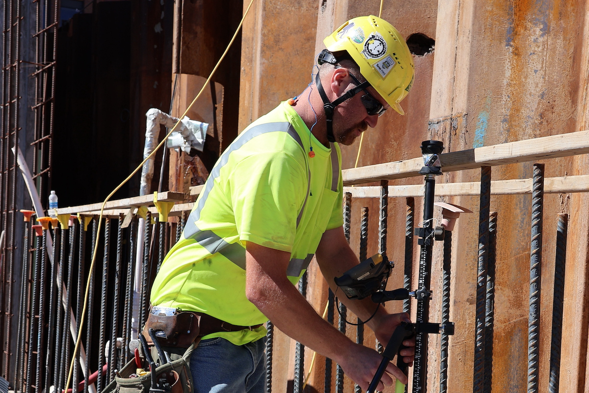 Foreman Dave Garnish verifies a point as one of the walls begins to take shape. Superintendent Jay Stanley estimates that, using the Topcon solution, establishing and verifying points is twice as fast and more than twice as accurate.