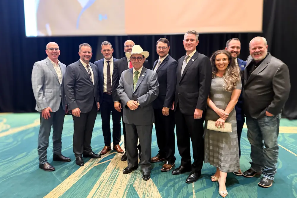 Texas State Senator Pete Flores (middle in the cowboy hat) poses with TACA President Andrew Pinkerton (fourth from the right) and TACA members at CIM gala.