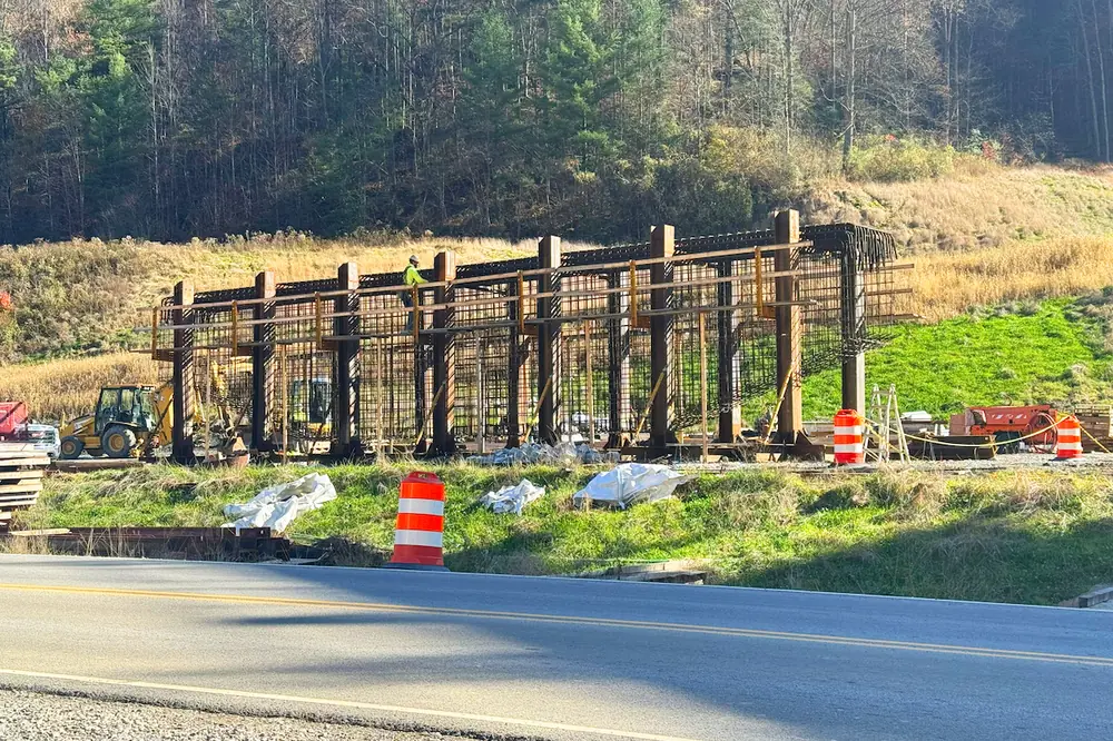 Reinforcing steel mats are assembled on the ground before a crane lifts them to the bridge pier.