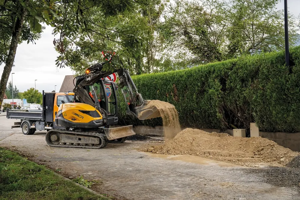From a single position, a crawler skid excavator can dig then swing up and dump into a truck.