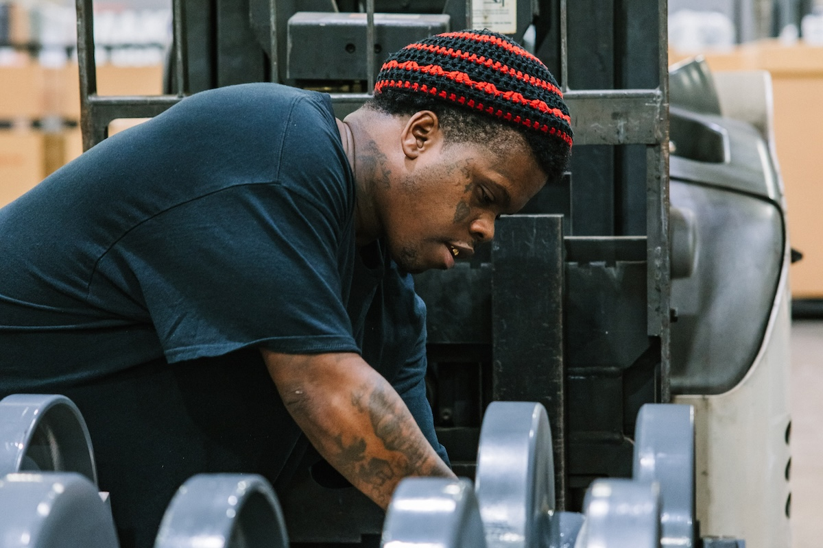 Jeremy Wilson works in Takeuchi’s warehouse.