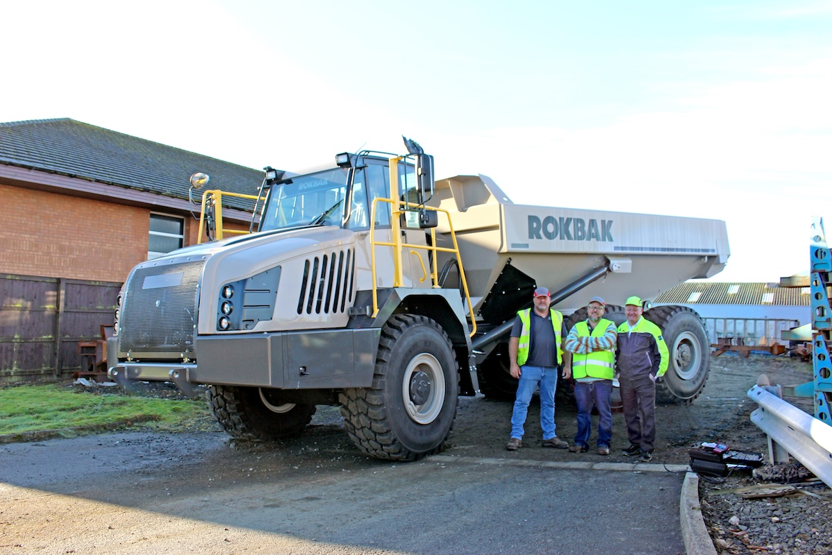Moore (right) with representatives from Florida dealer CASE Power & Equipment, who flew to Scotland for training.